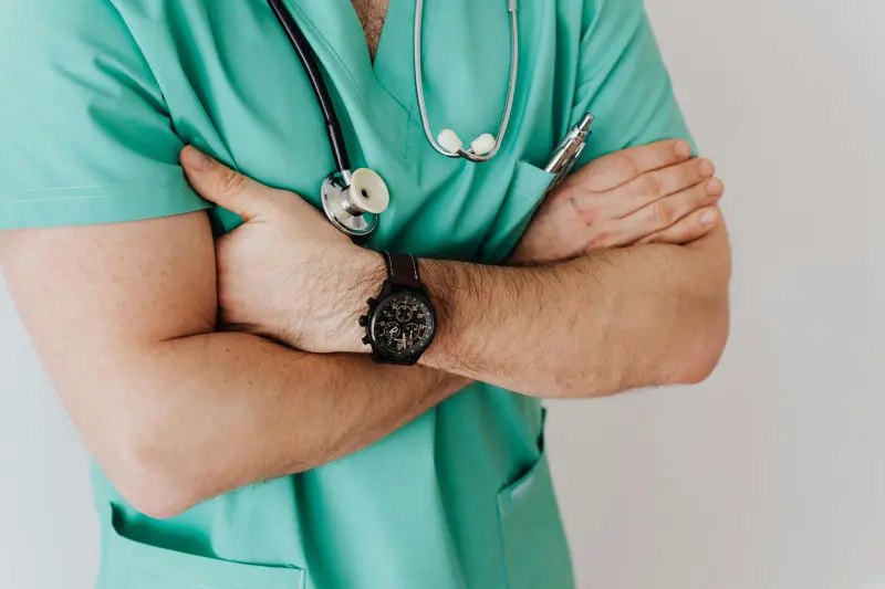 Trusted by Experts Doctor folded arms